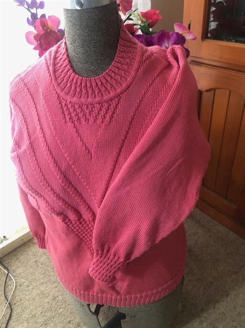 pink knitted jumper displayed on manikin