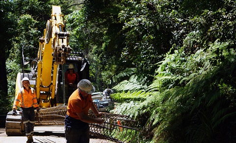 Workers moving pipe on Jamberoo Mtn Road